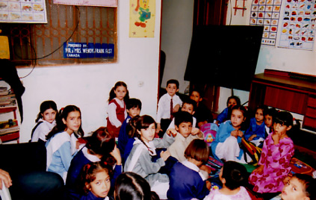 A One-room One teacher Home School managed by Tameer-e-Millat Foundation (TMF), in a rented living room of a family in Rawalpindi. Note: The students are all dressed up knowing that a foreign visitor is coming to take photos!